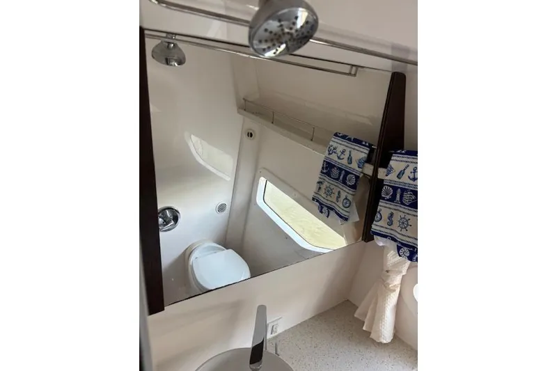 Slide: The Image of Bathroom interior of 2018 Regal 33 Express boat with nautical-themed decor. - 25