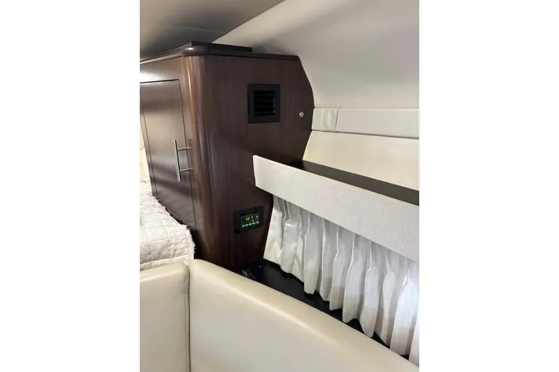 Slide: The Image of Interior of 2018 Regal 33 Express yacht with wood cabinet and white upholstery. - 27