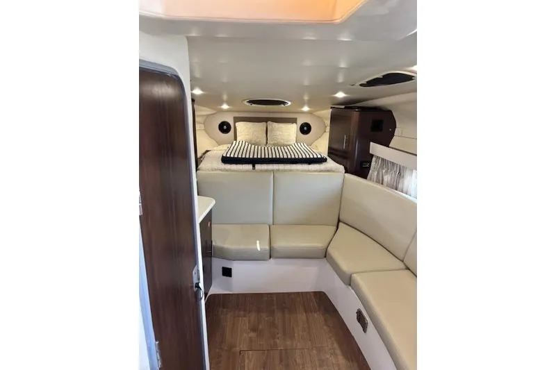 Slide: The Image of 2018 Regal 33 Express cabin interior with cozy seating and bed. - 28
