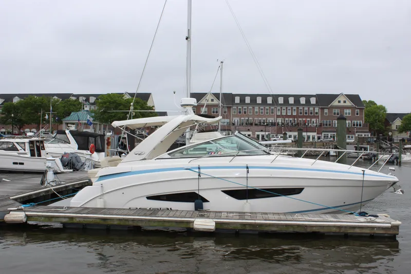 Slide: The Image of 2018 Regal 33 Express yacht docked at marina with buildings in background. - 3