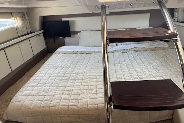 Slide: The Image of Luxurious cabin interior of 2018 Regal 33 Express yacht with cozy bed and TV. - 30
