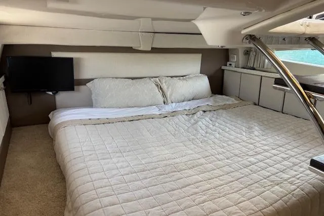 Slide: The Image of Luxurious cabin interior of 2018 Regal 33 Express yacht with cozy bedding and TV. - 31