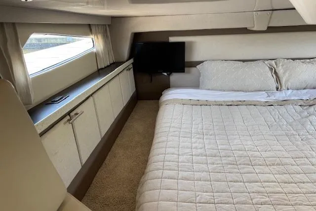 Slide: The Image of Luxurious cabin interior of 2018 Regal 33 Express yacht with bed and TV. - 32