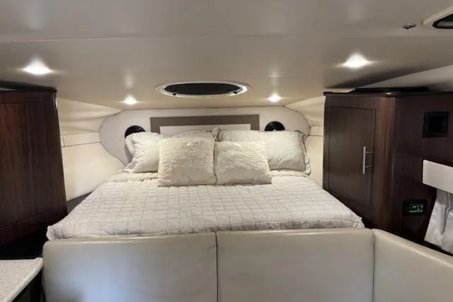 Slide: The Image of Luxurious cabin interior of 2018 Regal 33 Express yacht with cozy bed and ambient lighting. - 35
