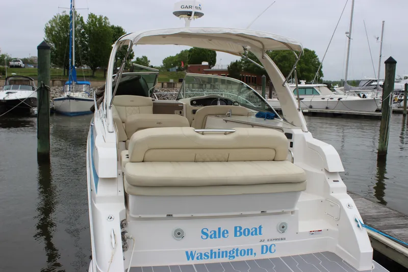 Slide: The Image of 2018 Regal 33 Express boat docked, featuring beige seating and "Sale Boat" text. - 5