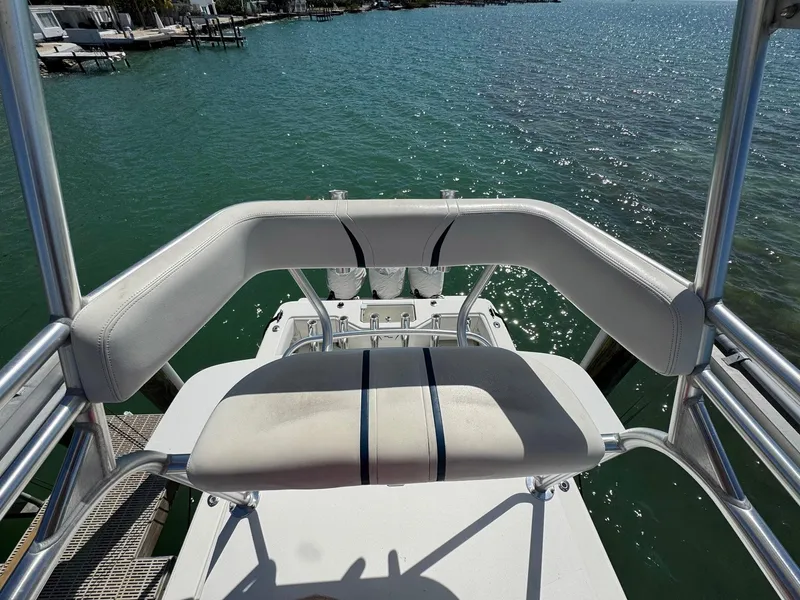Slide: The Image of 2014 SeaVee 390B Center Console boat with white seating, overlooking calm blue water. - 29