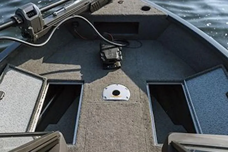 Slide: The Image of 2026 Crestliner 1650 HAWK SC boat interior with storage compartments and fishing equipment. - 4