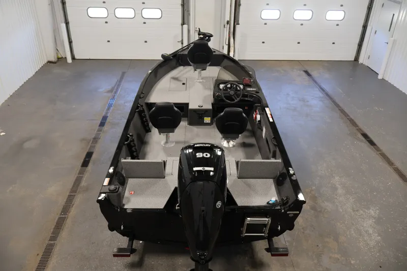 Slide: The Image of 2027 Crestliner 1650 HAWK SC fishing boat in a garage, featuring a Mercury outboard motor. - 14