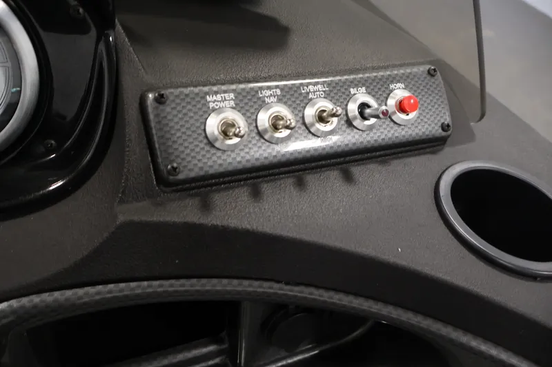 Slide: The Image of Control panel of 2027 Crestliner 1650 HAWK SC boat with switches and cup holder. - 31
