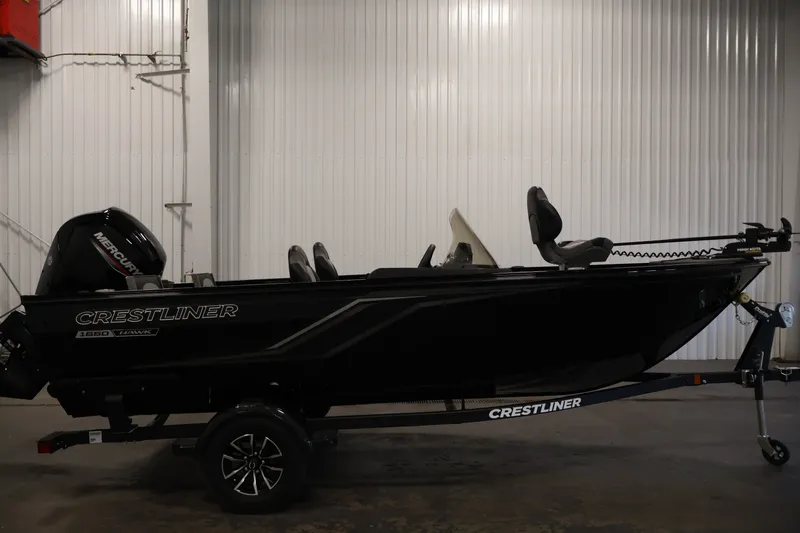 Slide: The Image of 2027 Crestliner 1650 HAWK SC fishing boat in a showroom, side view. - 8
