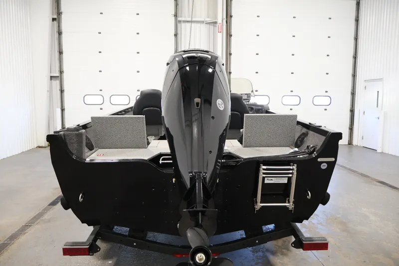 Slide: The Image of 2027 Crestliner 1650 HAWK SC boat in a garage, rear view with motor. - 10