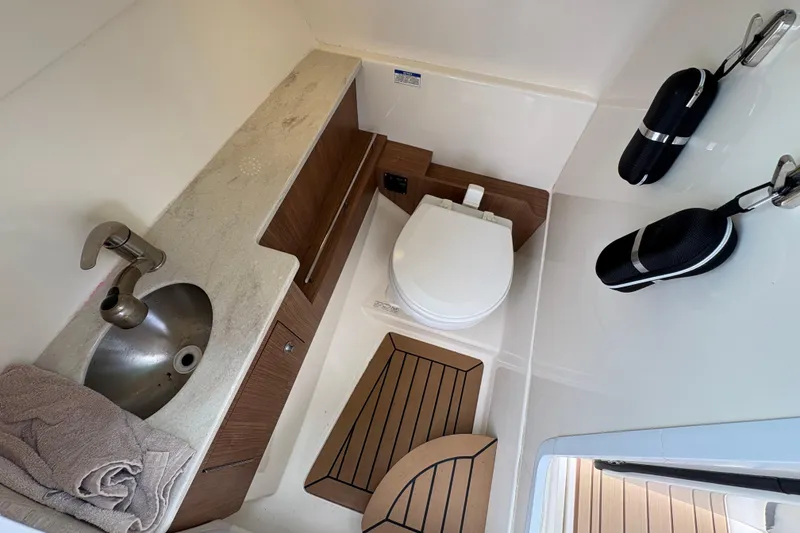 Slide: The Image of 2017 Boston Whaler 270 Vantage boat bathroom with sink, toilet, and storage. - 22