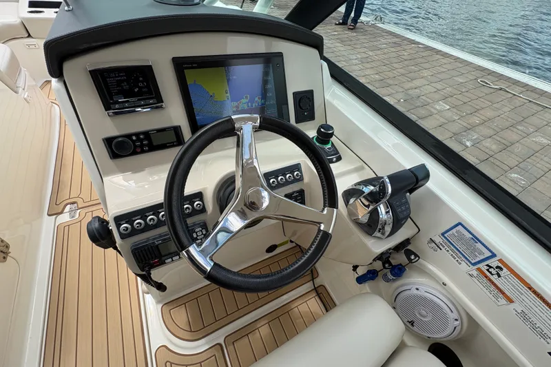 Slide: The Image of 2017 Boston Whaler 270 Vantage helm with navigation display and controls. - 28