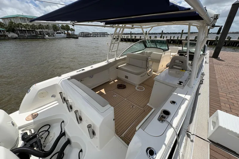 Slide: The Image of 2017 Boston Whaler 270 Vantage boat docked, featuring spacious seating and sleek design. - 31