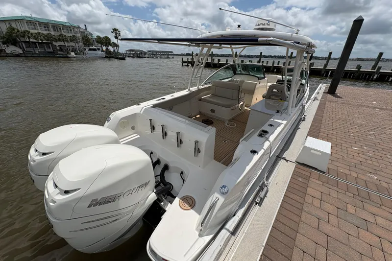 Slide: The Image of 2017 Boston Whaler 270 Vantage boat docked, featuring dual Mercury engines. - 33
