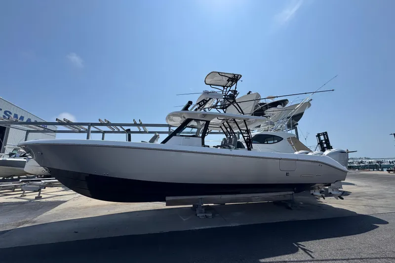 The Image of 2022 Everglades 395 Center Console boat displayed outdoors under clear blue sky. - 1