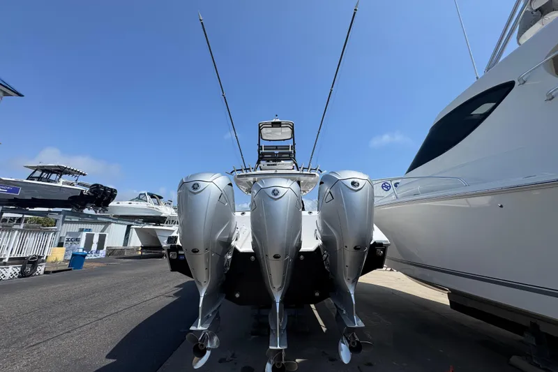 Slide: The Image of 2022 Everglades 395 Center Console boat with triple outboard engines, docked at marina. - 11
