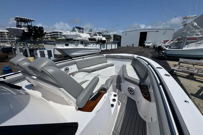 Slide: The Image of 2022 Everglades 395 Center Console boat with spacious seating and modern design in a marina. - 13