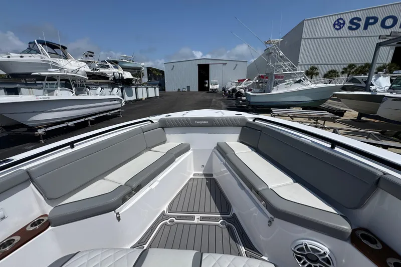 Slide: The Image of 2022 Everglades 395 Center Console boat interior with gray seating, docked at a marina. - 14