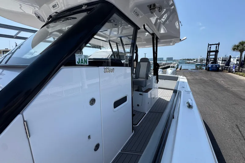 Slide: The Image of 2022 Everglades 395 Center Console boat docked near marina under clear sky. - 20
