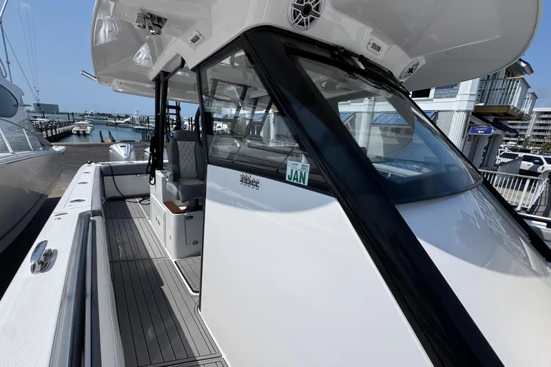 Slide: The Image of 2022 Everglades 395 Center Console boat docked at marina, showcasing sleek design and spacious deck. - 21