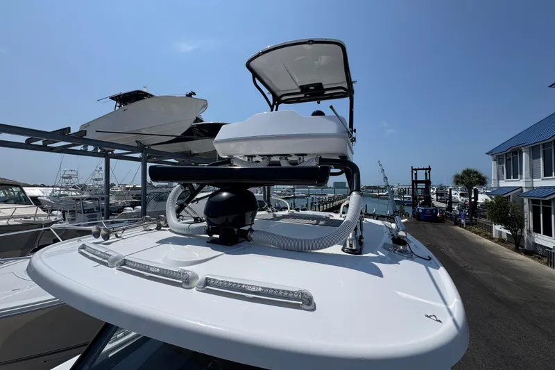 Slide: The Image of 2022 Everglades 395 Center Console boat docked at a marina under clear blue skies. - 22