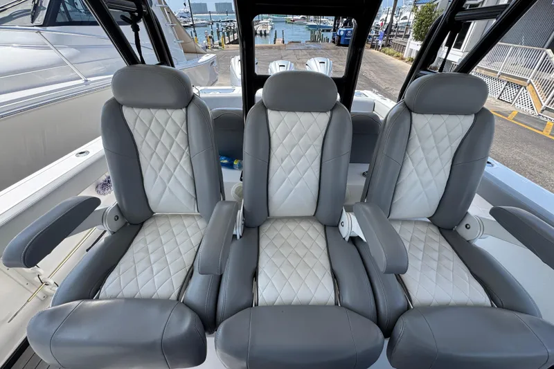 Slide: The Image of Luxury seating on 2022 Everglades 395 Center Console boat, featuring quilted upholstery. - 24