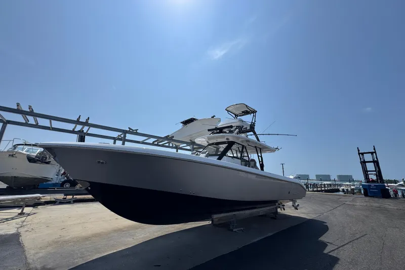 Slide: The Image of 2022 Everglades 395 Center Console boat on dry dock under clear blue sky. - 3