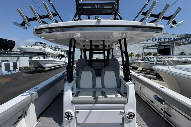 Slide: The Image of 2022 Everglades 395 Center Console boat with seating and rod holders at a marina. - 32