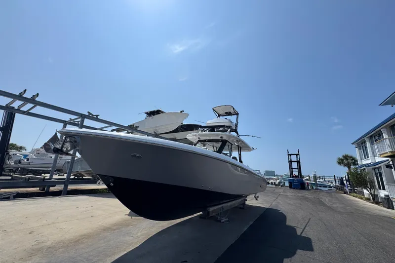 Slide: The Image of 2022 Everglades 395 Center Console boat on a sunny day at a marina. - 4