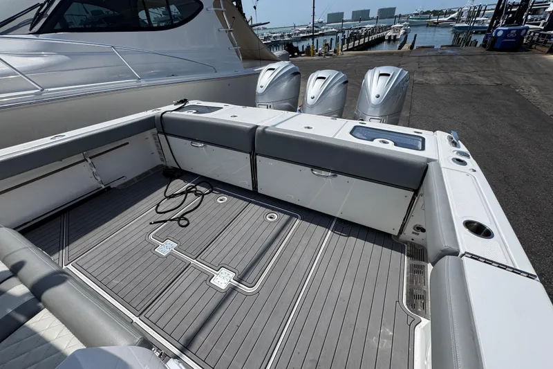 Slide: The Image of 2022 Everglades 395 Center Console boat with spacious deck and triple outboard engines. - 41