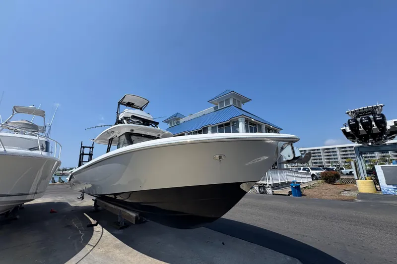 Slide: The Image of 2022 Everglades 395 Center Console boat docked near marina buildings. - 7