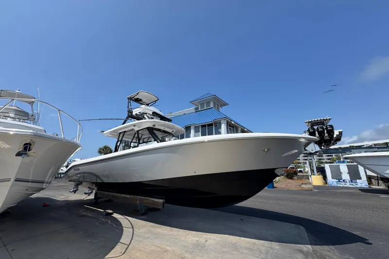 Slide: The Image of 2022 Everglades 395 Center Console boat on display at a marina. - 8