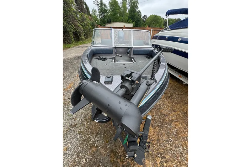 Slide: The Image of 2013 Ranger 1850 LS boat with trolling motor, parked outdoors. - 14