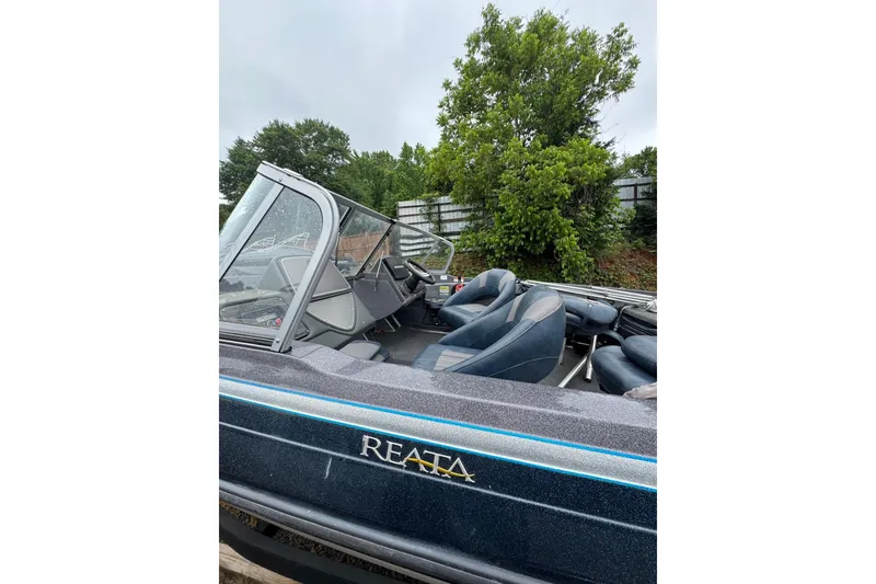 Slide: The Image of 2013 Ranger 1850 LS boat interior with blue seats and windshield. - 6