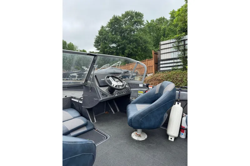 Slide: The Image of 2013 Ranger 1850 LS boat interior with steering wheel and blue seats. - 7