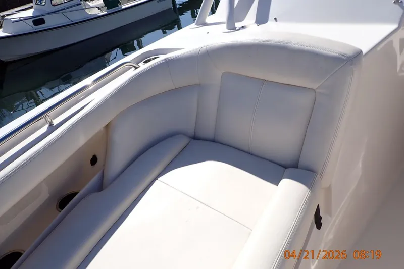 Slide: The Image of Luxurious seating on a 2016 Grady-White Freedom 335 boat, docked in sunlight. - 12