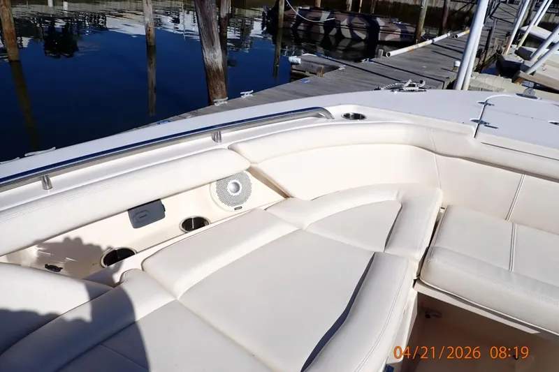 Slide: The Image of 2016 Grady-White Freedom 335 boat interior with cushioned seating at dock. - 15