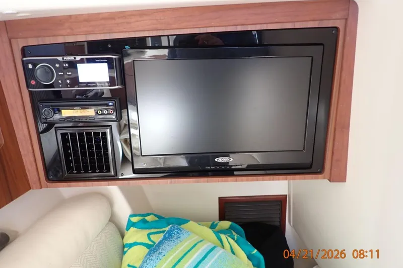 Slide: The Image of Entertainment system in 2016 Grady-White Freedom 335 boat cabin with TV and audio controls. - 17