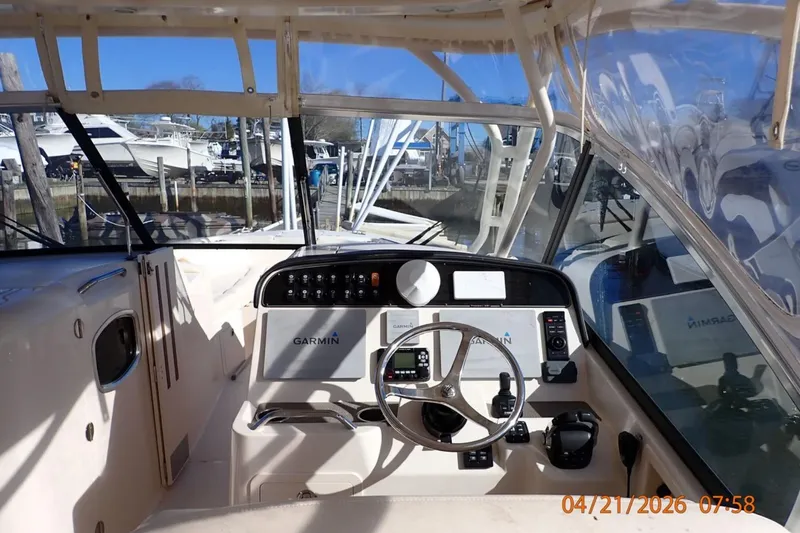 Slide: The Image of 2016 Grady-White Freedom 335 boat cockpit with Garmin navigation system. - 21