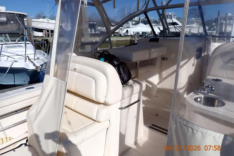 Slide: The Image of 2016 Grady-White Freedom 335 boat interior with seating and helm station. - 25