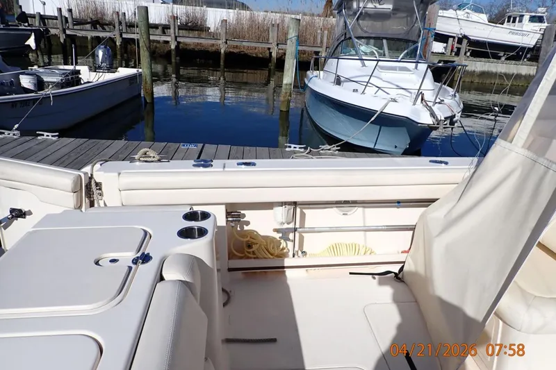 Slide: The Image of 2016 Grady-White Freedom 335 boat docked at marina with clear sky. - 26