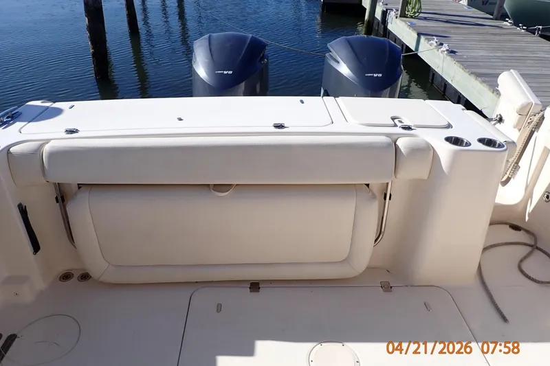Slide: The Image of 2016 Grady-White Freedom 335 boat interior with dual engines at dock. - 28