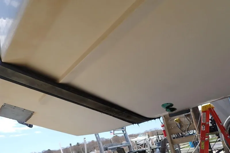 Slide: The Image of 2016 Grady-White Freedom 335 boat hull underside with ladder and equipment nearby. - 29