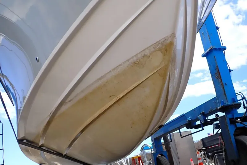Slide: The Image of 2016 Grady-White Freedom 335 boat hull on lift, showing underside details. - 31