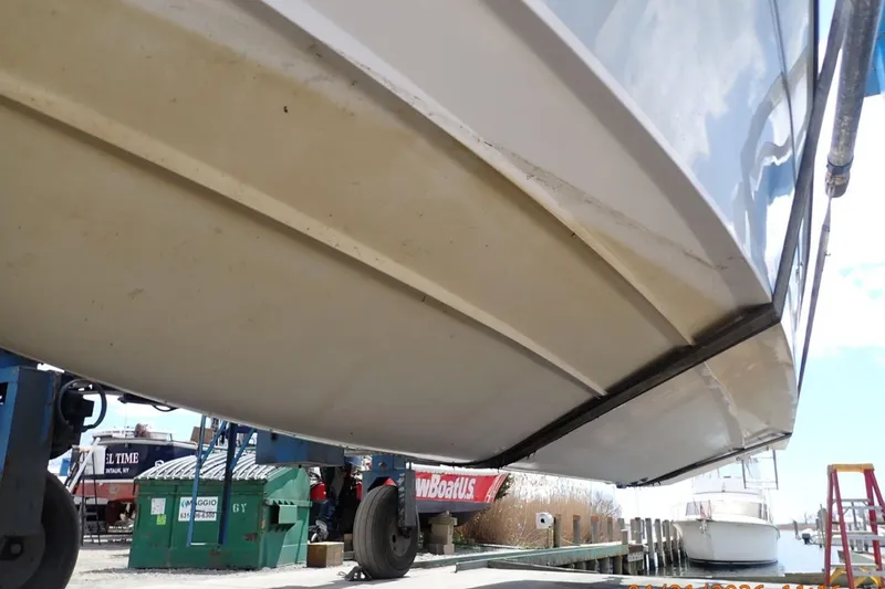 Slide: The Image of 2016 Grady-White Freedom 335 boat hull on trailer at marina. - 35
