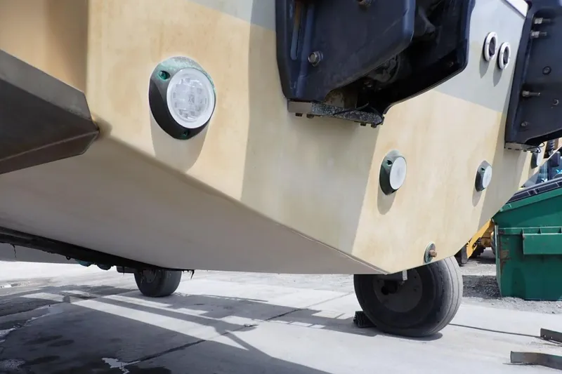 Slide: The Image of 2016 Grady-White Freedom 335 boat hull with underwater lights in a maintenance area. - 37