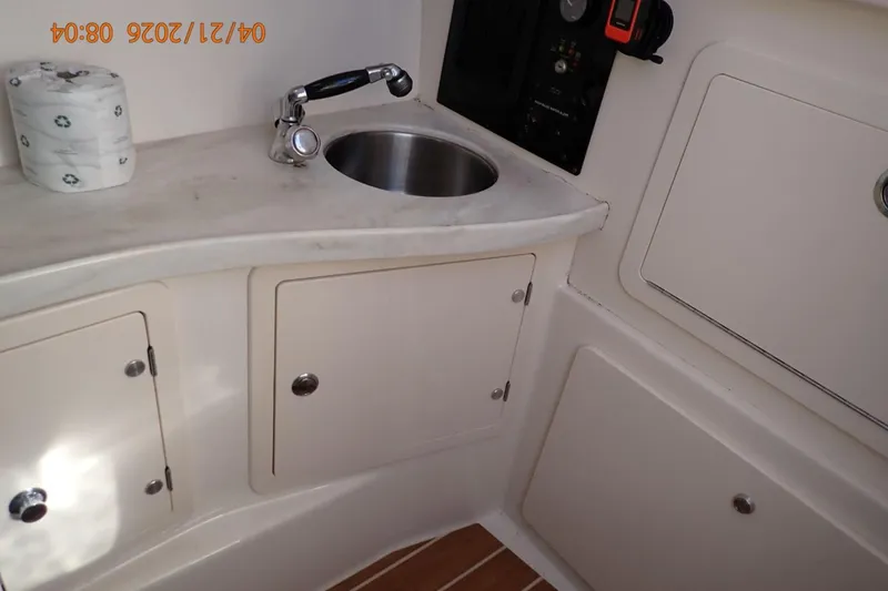 Slide: The Image of 2016 Grady-White Freedom 335 boat interior with sink and storage cabinets. - 38