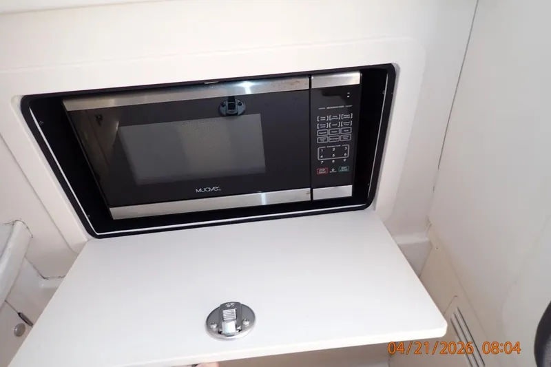 Slide: The Image of Built-in microwave on 2016 Grady-White Freedom 335 boat, with control panel visible. - 39