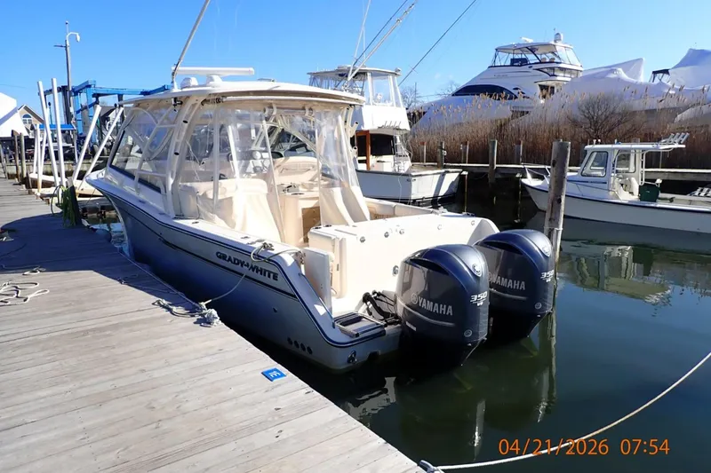 Slide: The Image of 2016 Grady-White Freedom 335 boat docked with twin Yamaha engines. - 4